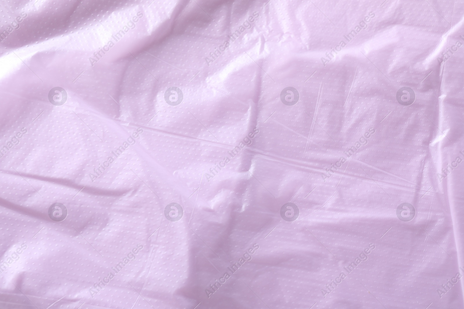 Photo of Texture of violet plastic bag as background, closeup