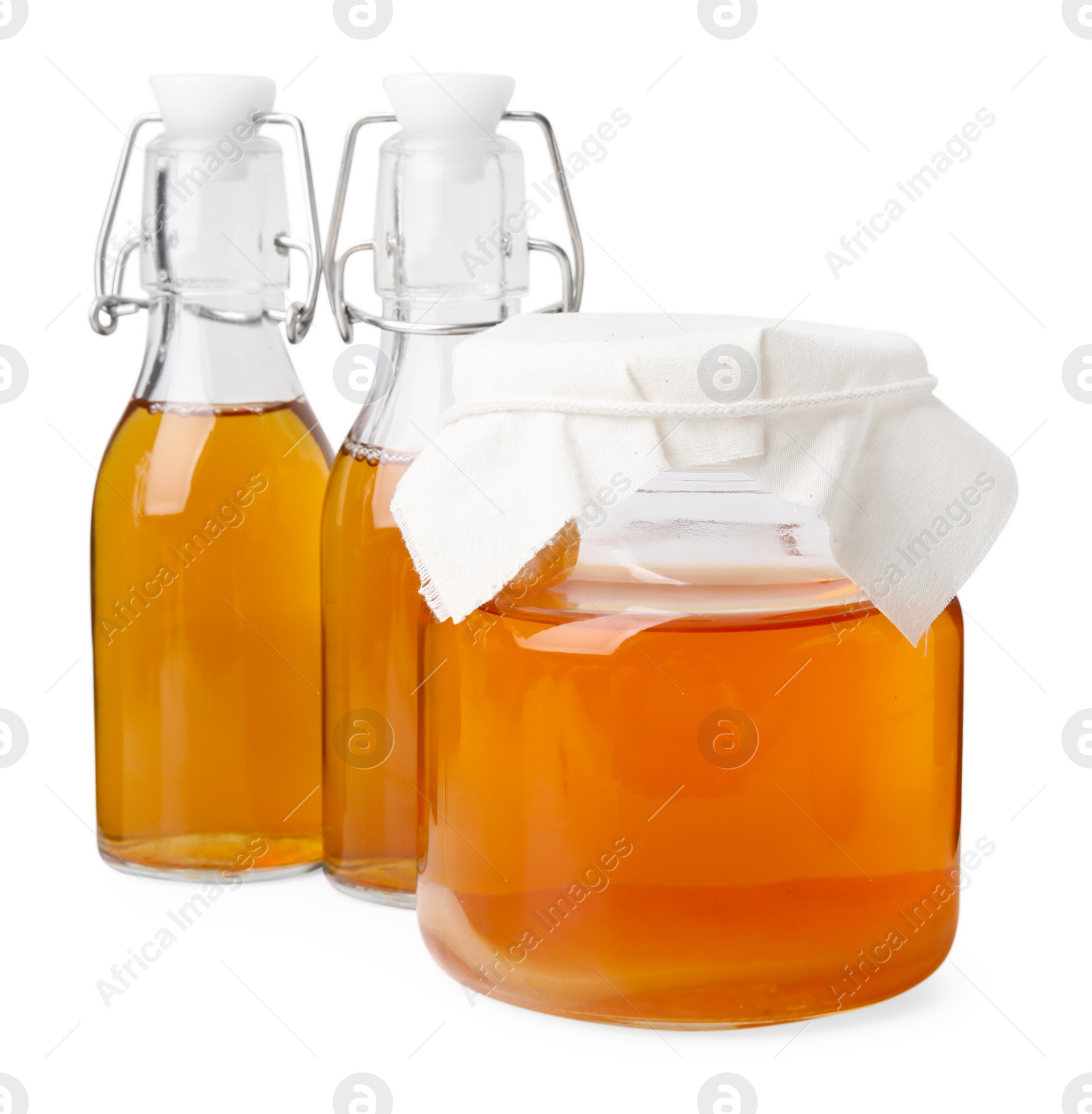 Photo of Tasty kombucha in glass jar and bottles isolated on white