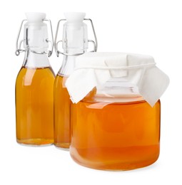 Tasty kombucha in glass jar and bottles isolated on white