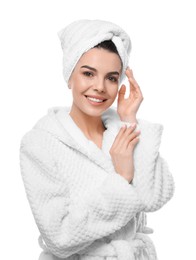 Happy young woman in bathrobe with towel on head against white background. Washing hair