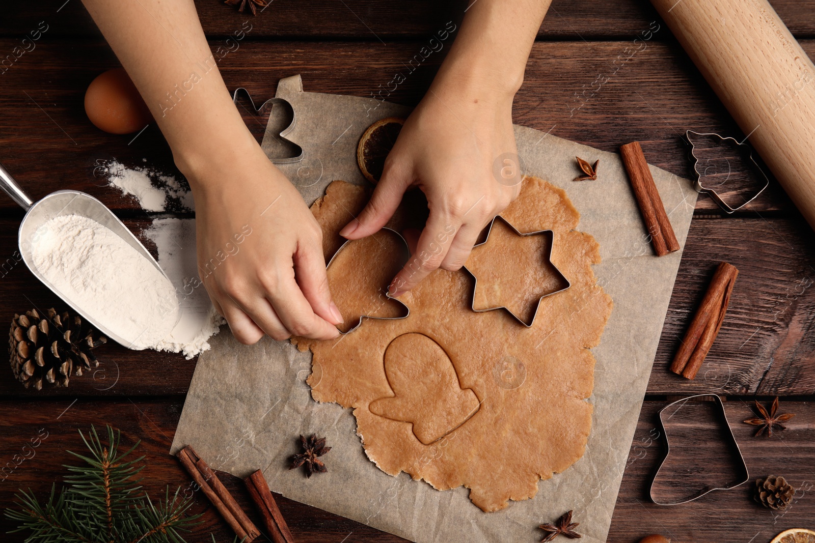 Photo of Woman making Christmas cookies at wooden table, top view