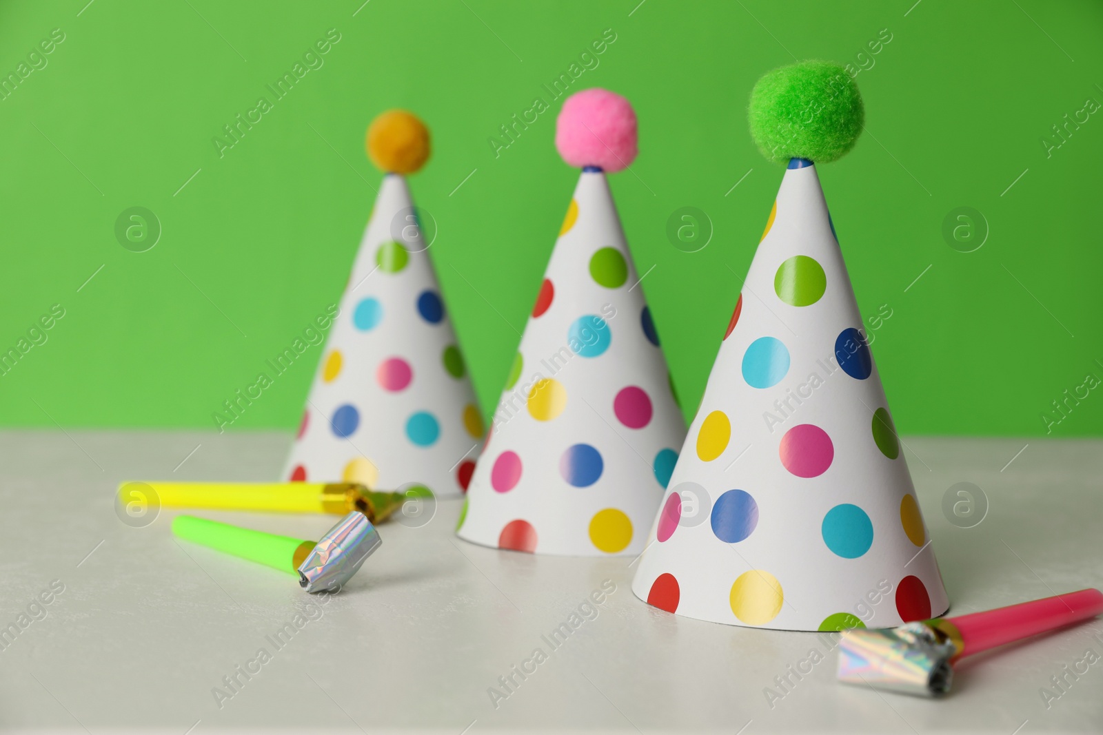 Photo of Birthday party hats and horns on light table