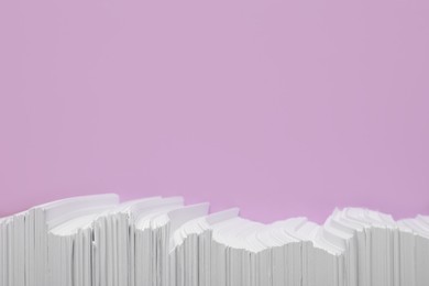 Photo of White paper sheets on violet background, flat lay. Space for text