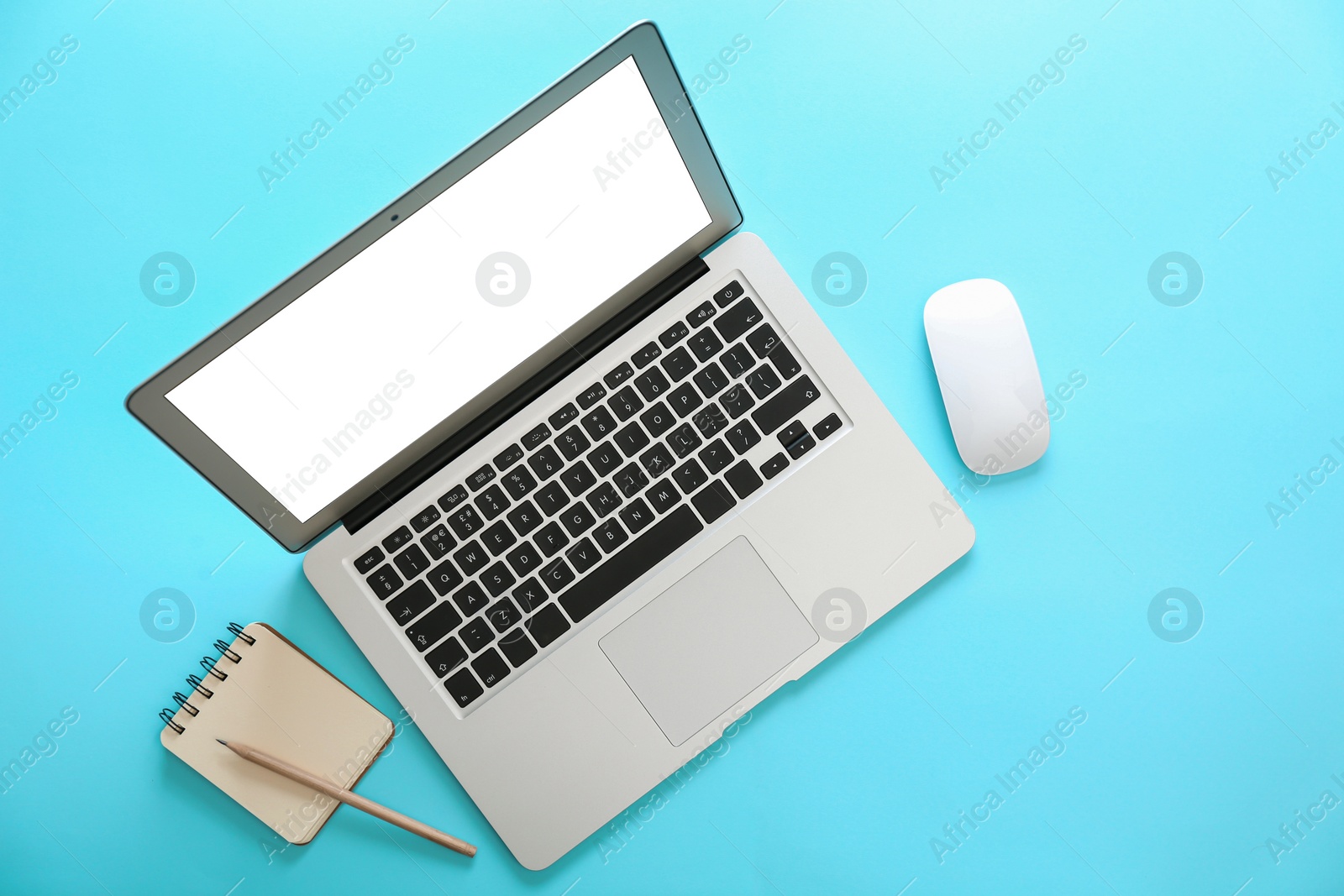 Photo of Laptop and office stationery on light blue background, flat lay