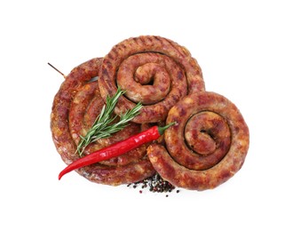 Photo of Rings of delicious homemade sausage with spices and chili pepper isolated on white, top view