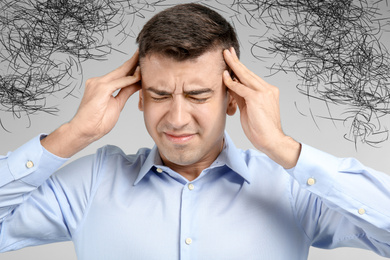 Image of Stressed man with mess in his head on light background