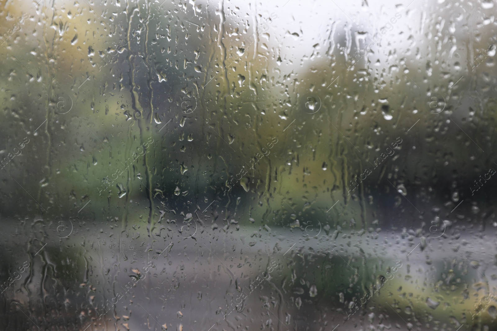 Photo of Window glass with water drops, closeup. Rainy weather