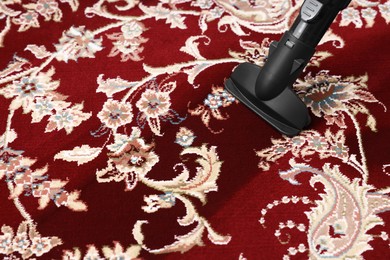 Photo of Hoovering carpet with vacuum cleaner, space for text