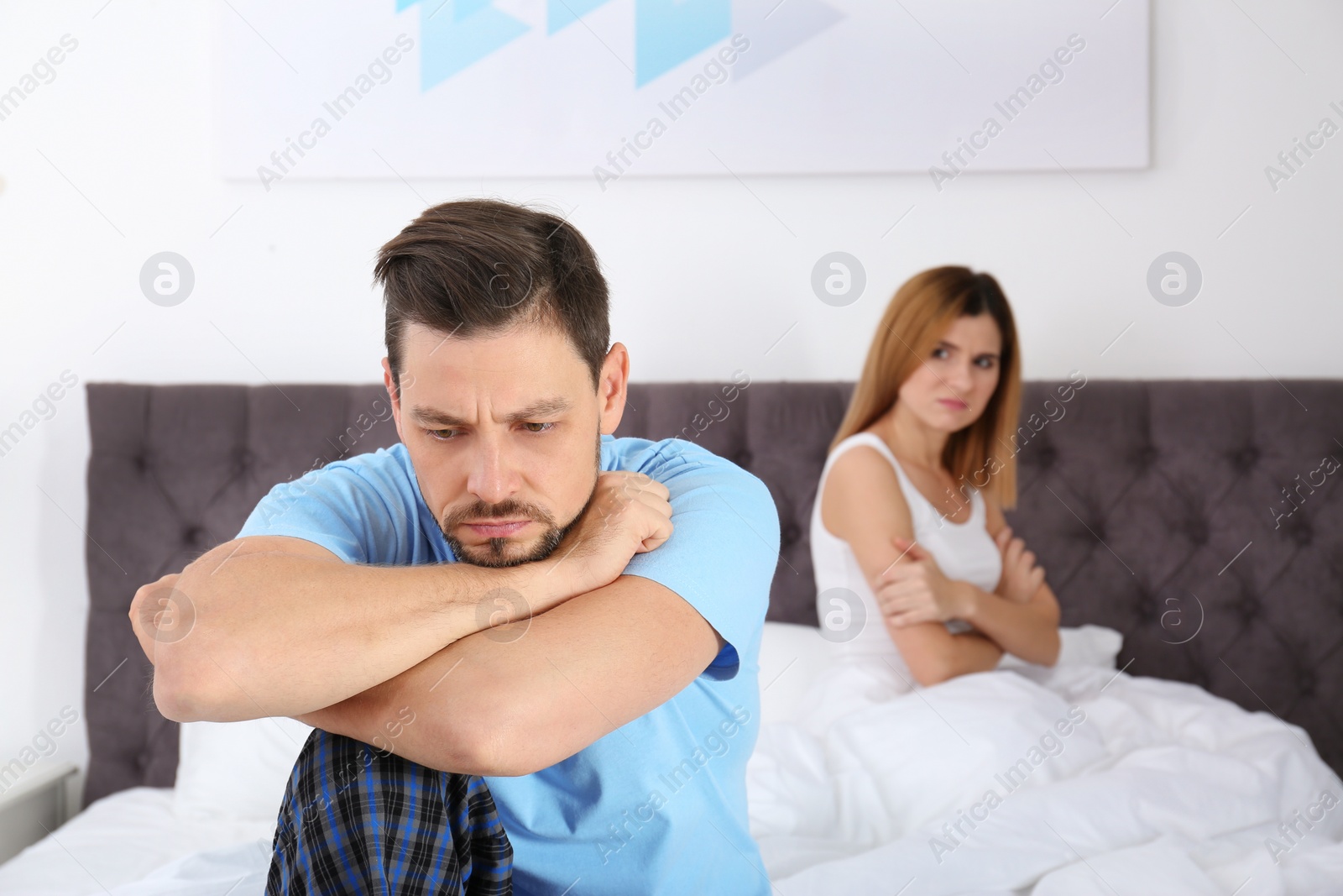 Photo of Couple with relationship problems ignoring each other in bedroom