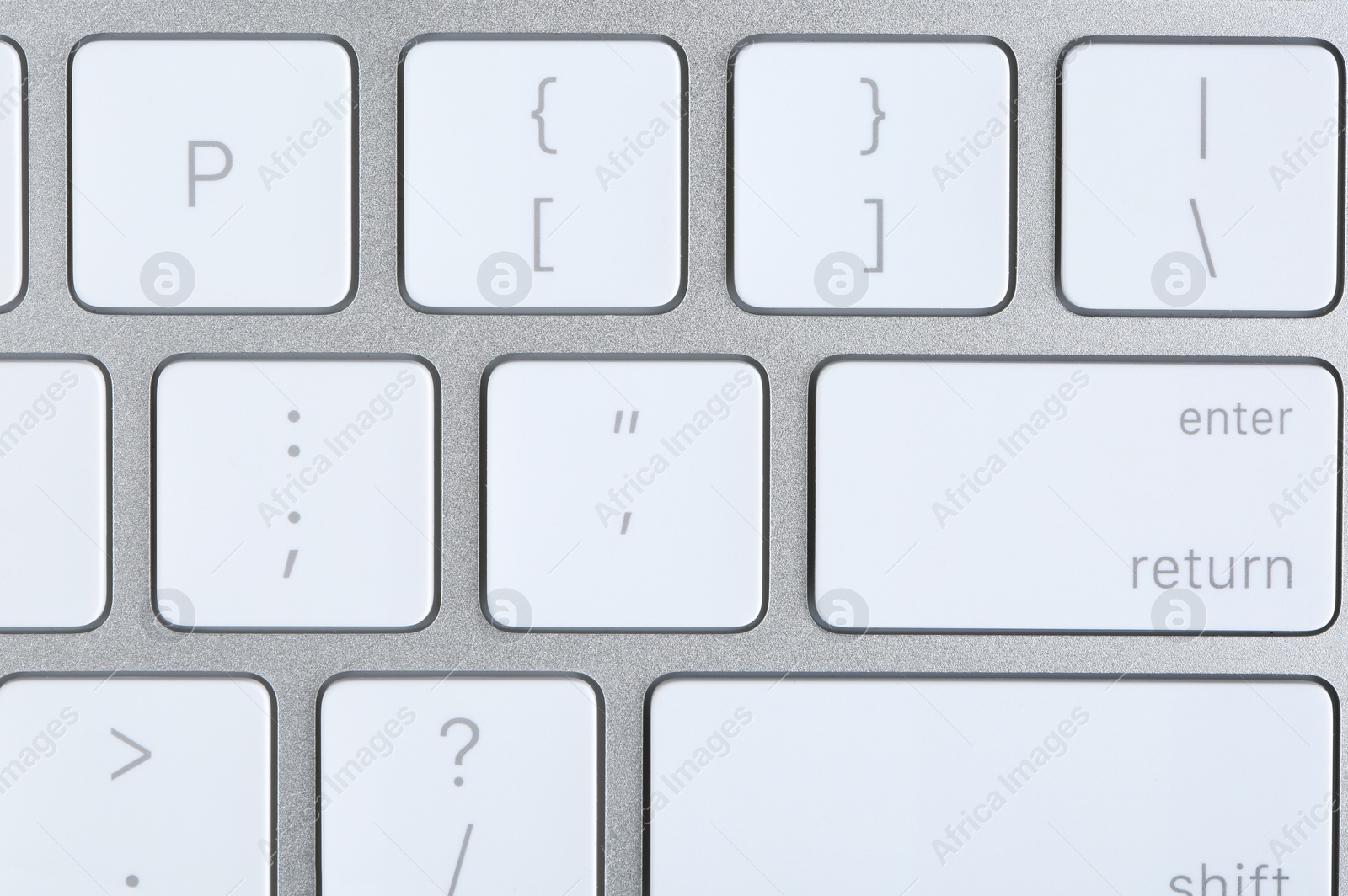 Photo of Modern computer keyboard with white buttons, closeup view