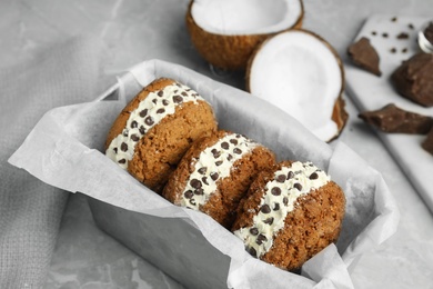 Photo of Sweet delicious ice cream cookie sandwiches with chocolate chips served on table