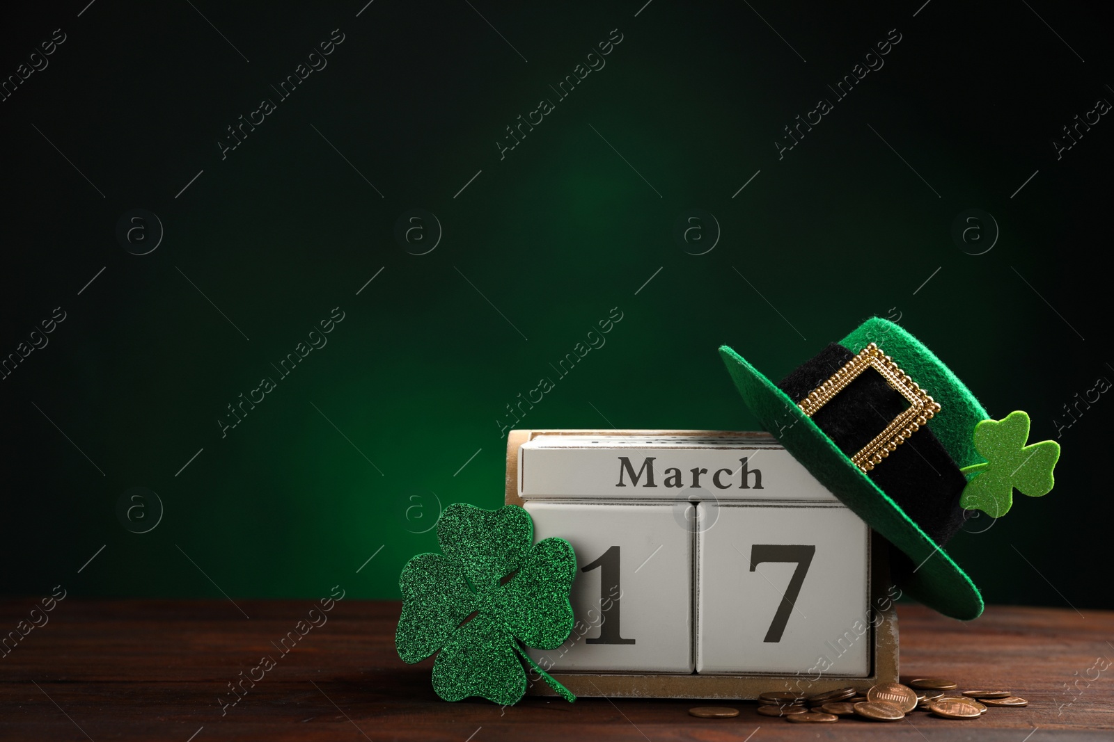 Photo of Composition with block calendar on wooden table, space for text. St. Patrick's Day celebration