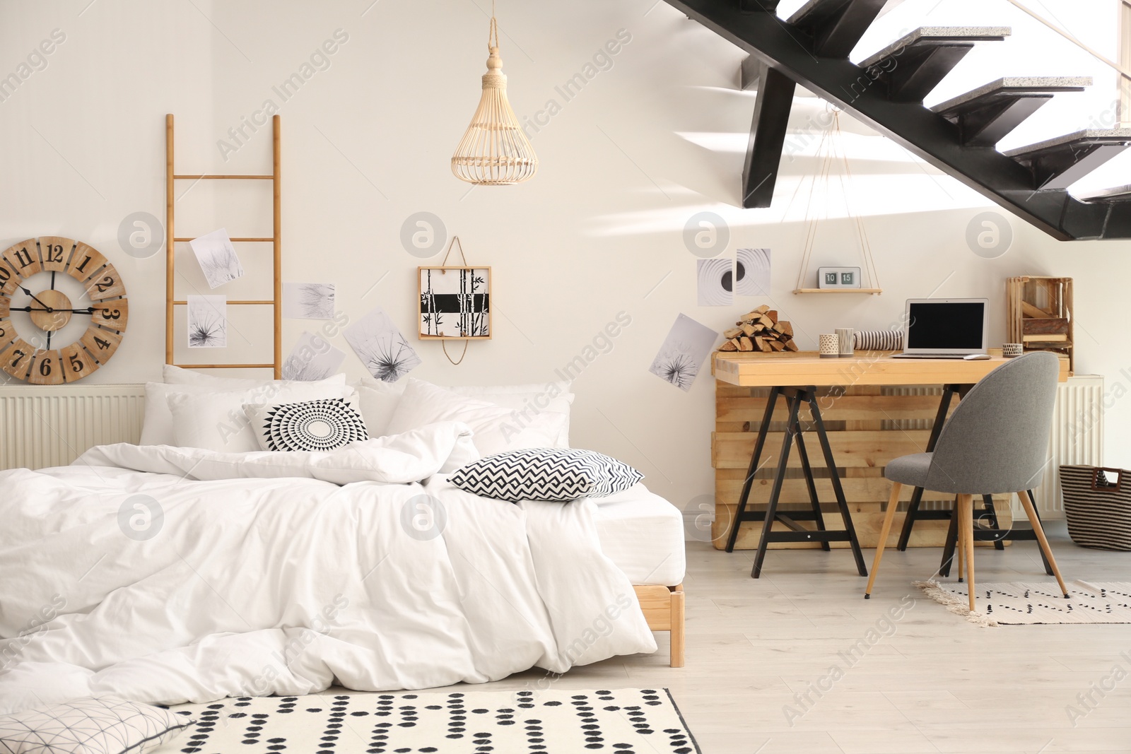 Photo of Elegant interior of bedroom with workplace under stairs