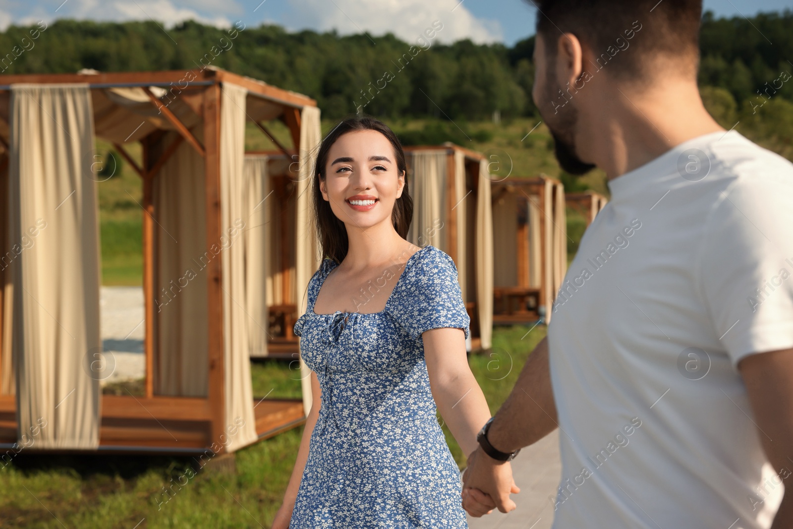 Photo of Romantic date. Beautiful couple walking outdoors on sunny day