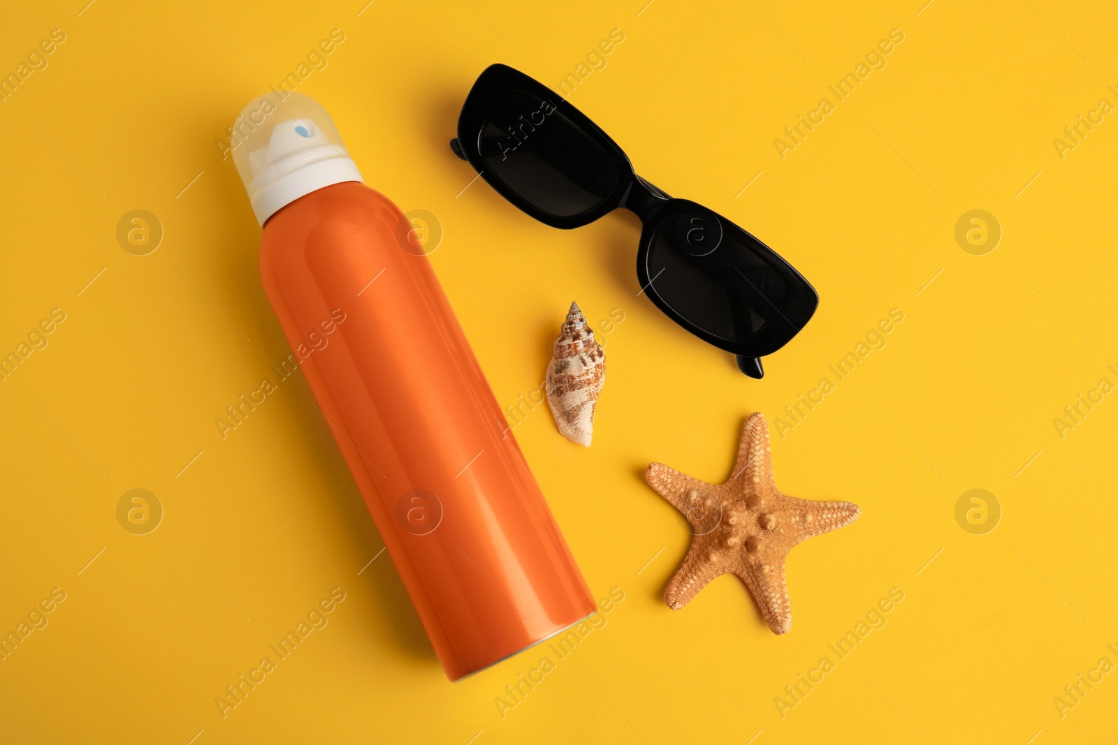 Photo of Flat lay composition with bottle of sunscreen on yellow background