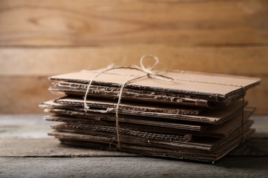 Photo of Stack of waste paper on wooden table, closeup