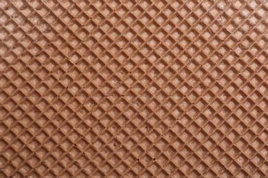 Photo of Tasty wafer as background, closeup. Crispy food