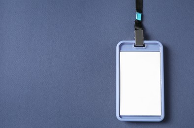 Photo of Blank badge with string on blue background, top view. Space for text