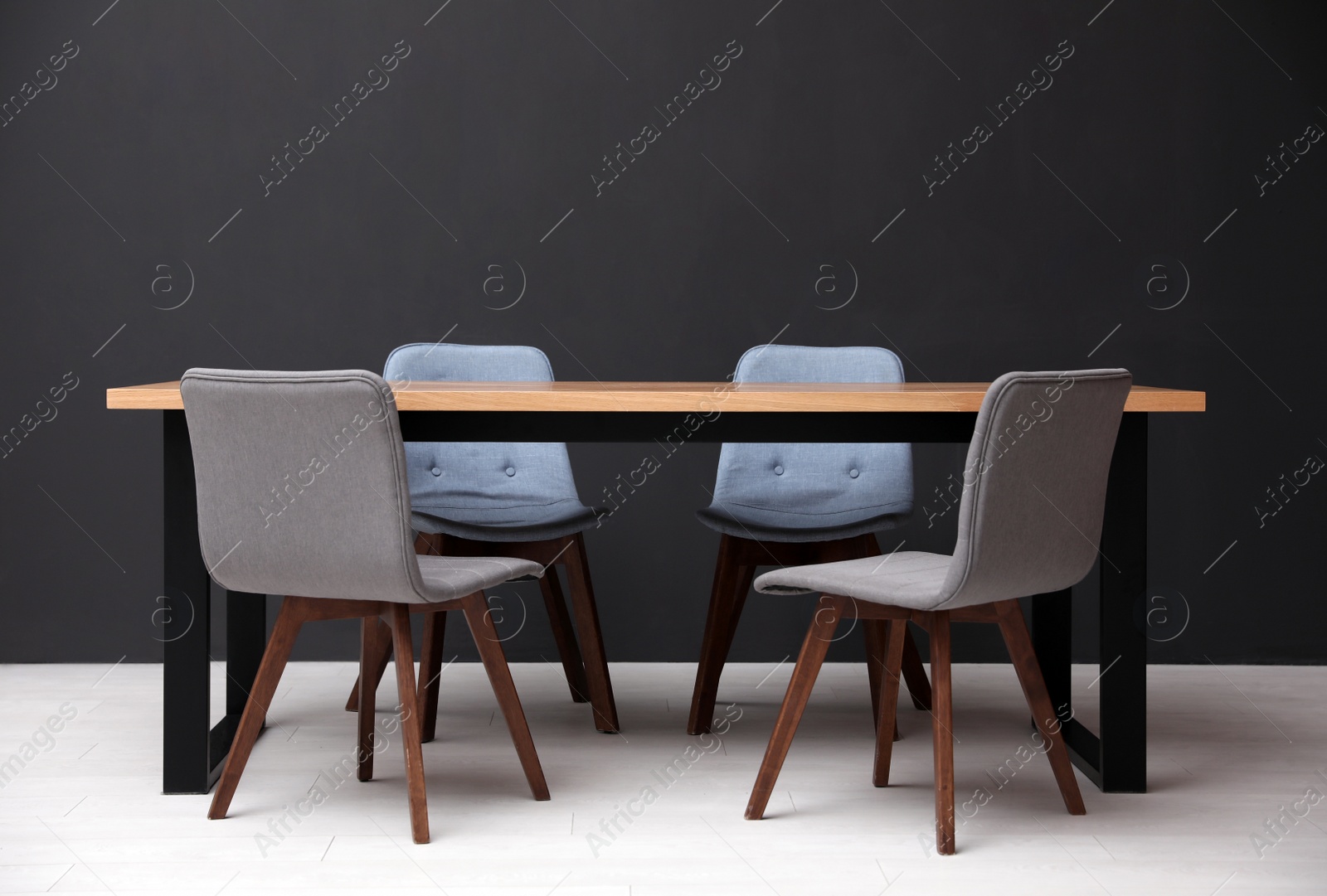 Photo of Modern empty wooden table near black wall