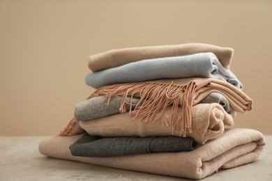 Stack of cashmere clothes on stone table