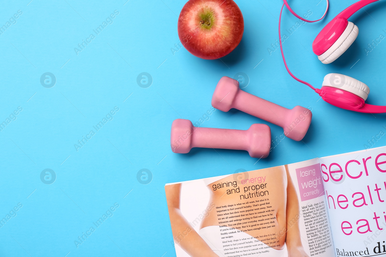 Photo of Flat lay composition with dumbbells on light blue background, space for text