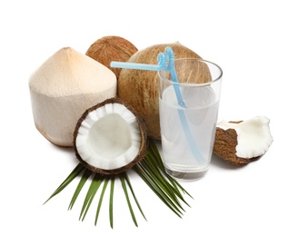 Glass of coconut milk and nuts on white background