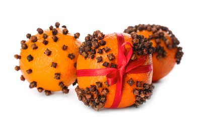Pomander balls made of fresh tangerines and cloves on white background