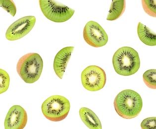 Set with cut ripe kiwi fruits falling on white background