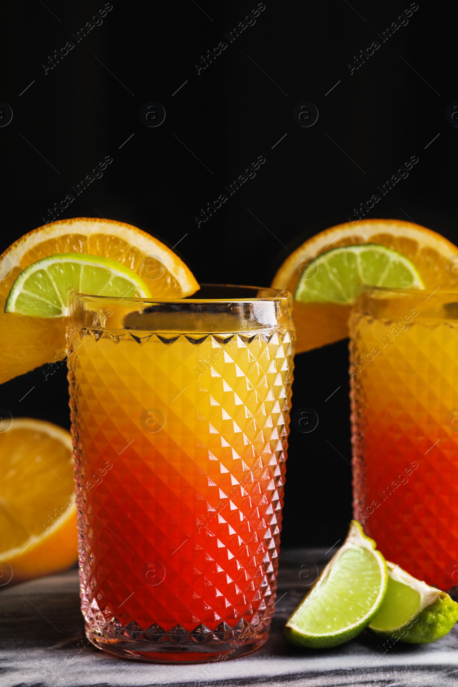 Photo of Fresh alcoholic Tequila Sunrise cocktails on marble board