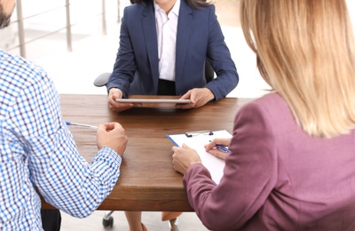 Photo of Human resources manager conducting job interview with applicants in office