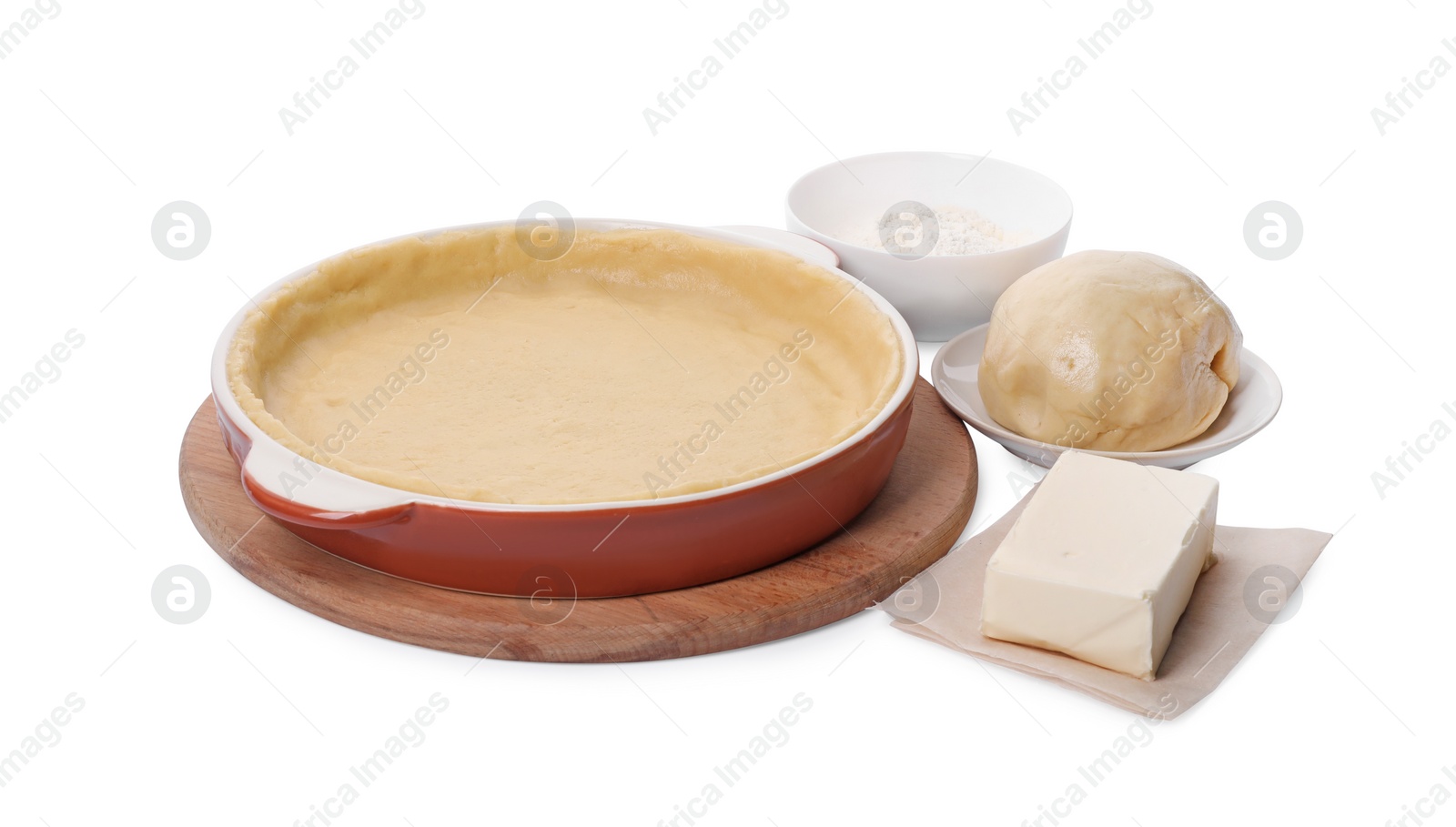 Photo of Pie tin with fresh dough and ingredients isolated on white. Making quiche