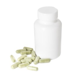 Photo of Bottle and pile of vitamin pills isolated on white