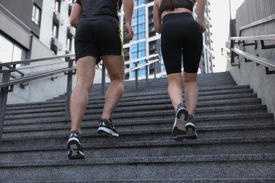 Photo of Healthy lifestyle. Couple running up steps outdoors, closeup