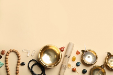 Photo of Flat lay composition with golden singing bowl on beige background, space for text. Sound healing