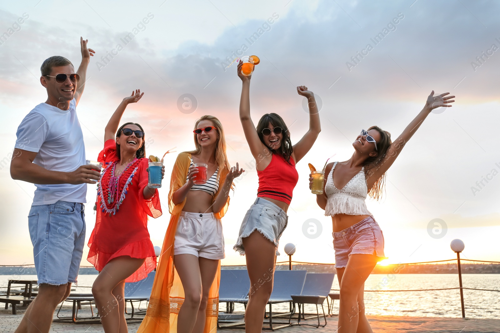 Photo of Group of happy people enjoying fun party outdoors