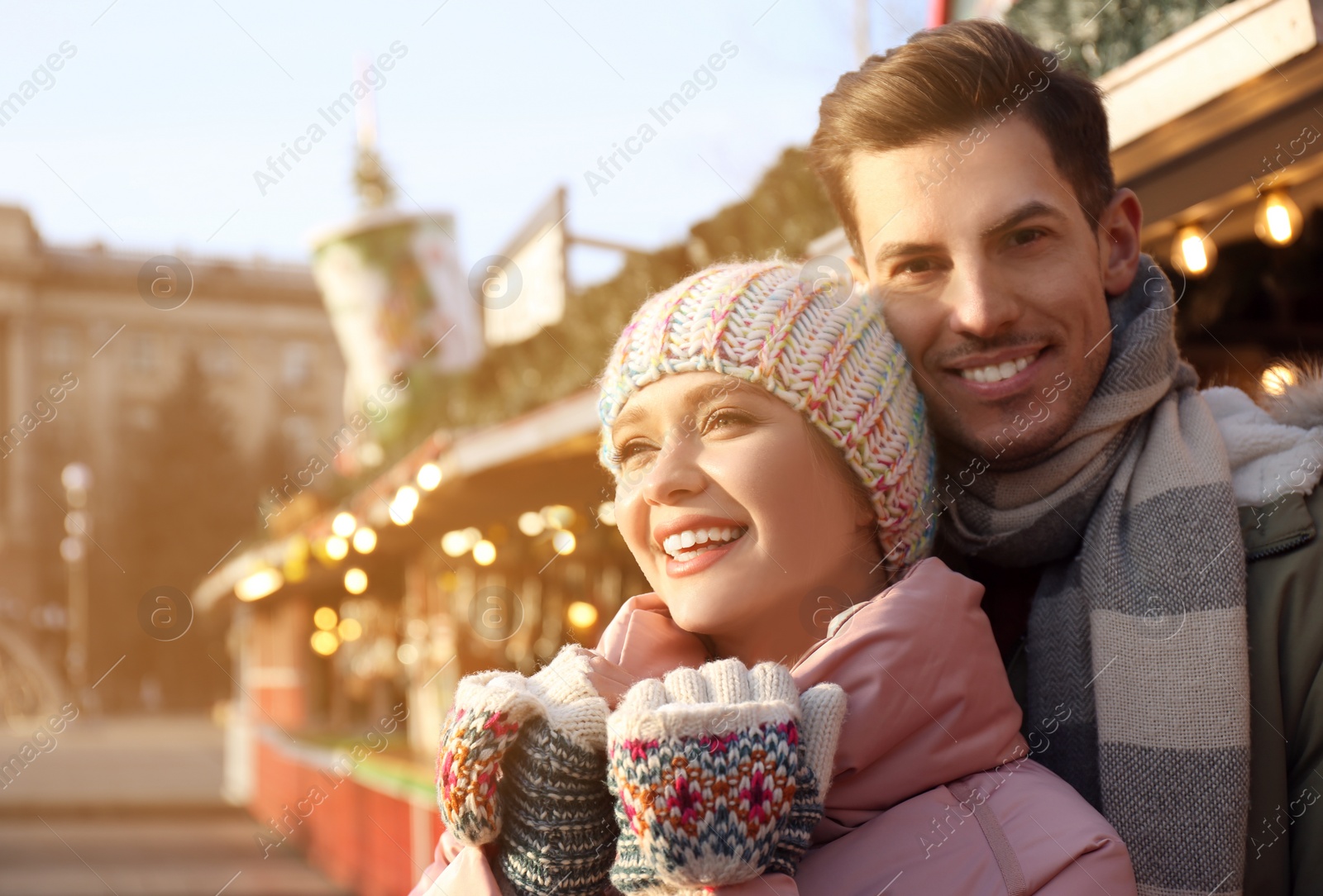 Photo of Happy couple at winter fair, space for text. Christmas celebration