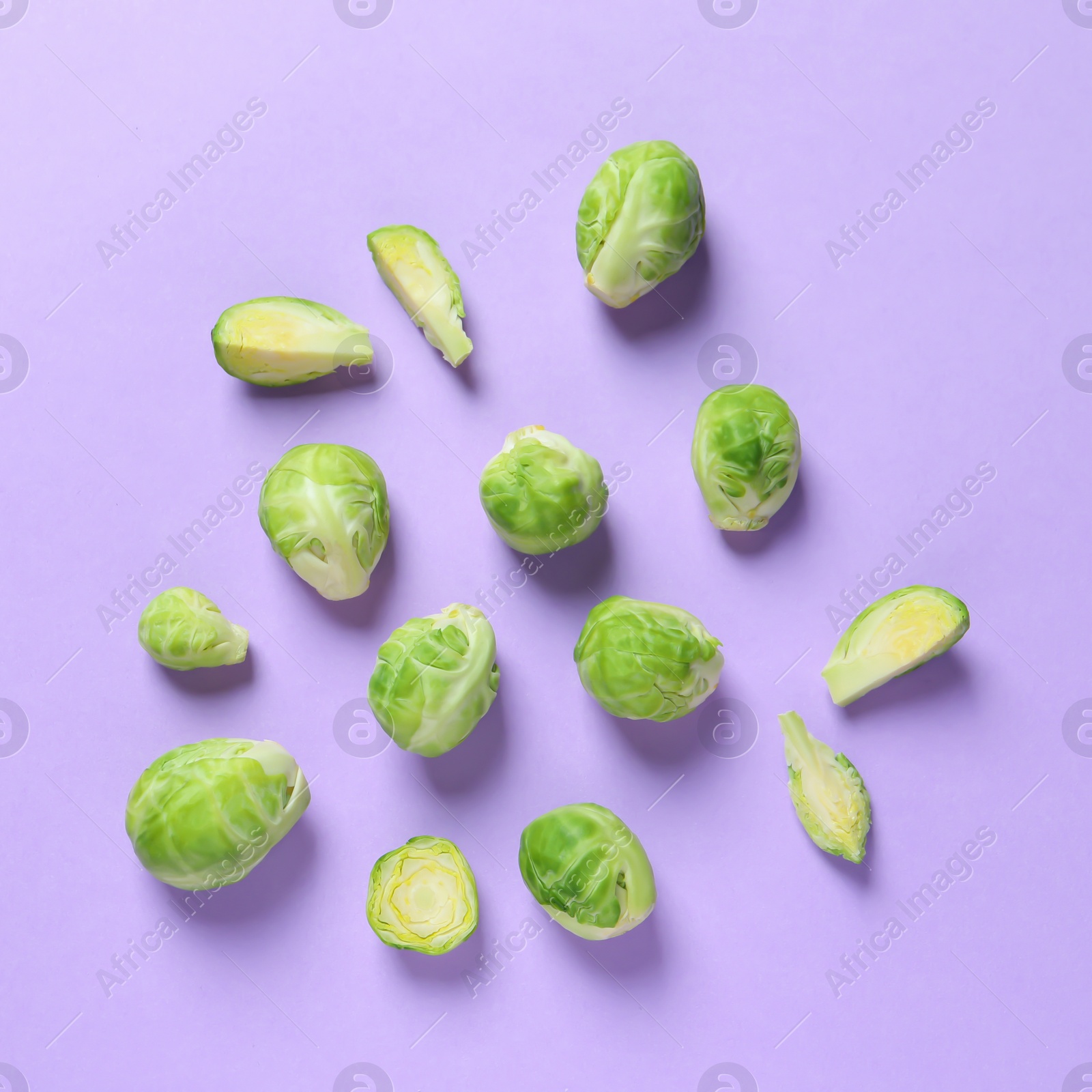 Photo of Fresh Brussels sprouts on color background, flat lay