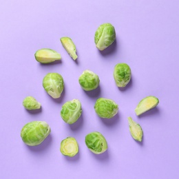 Photo of Fresh Brussels sprouts on color background, flat lay