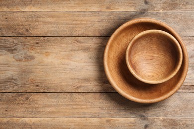 Empty clean wooden dishware on table, top view. Space for text