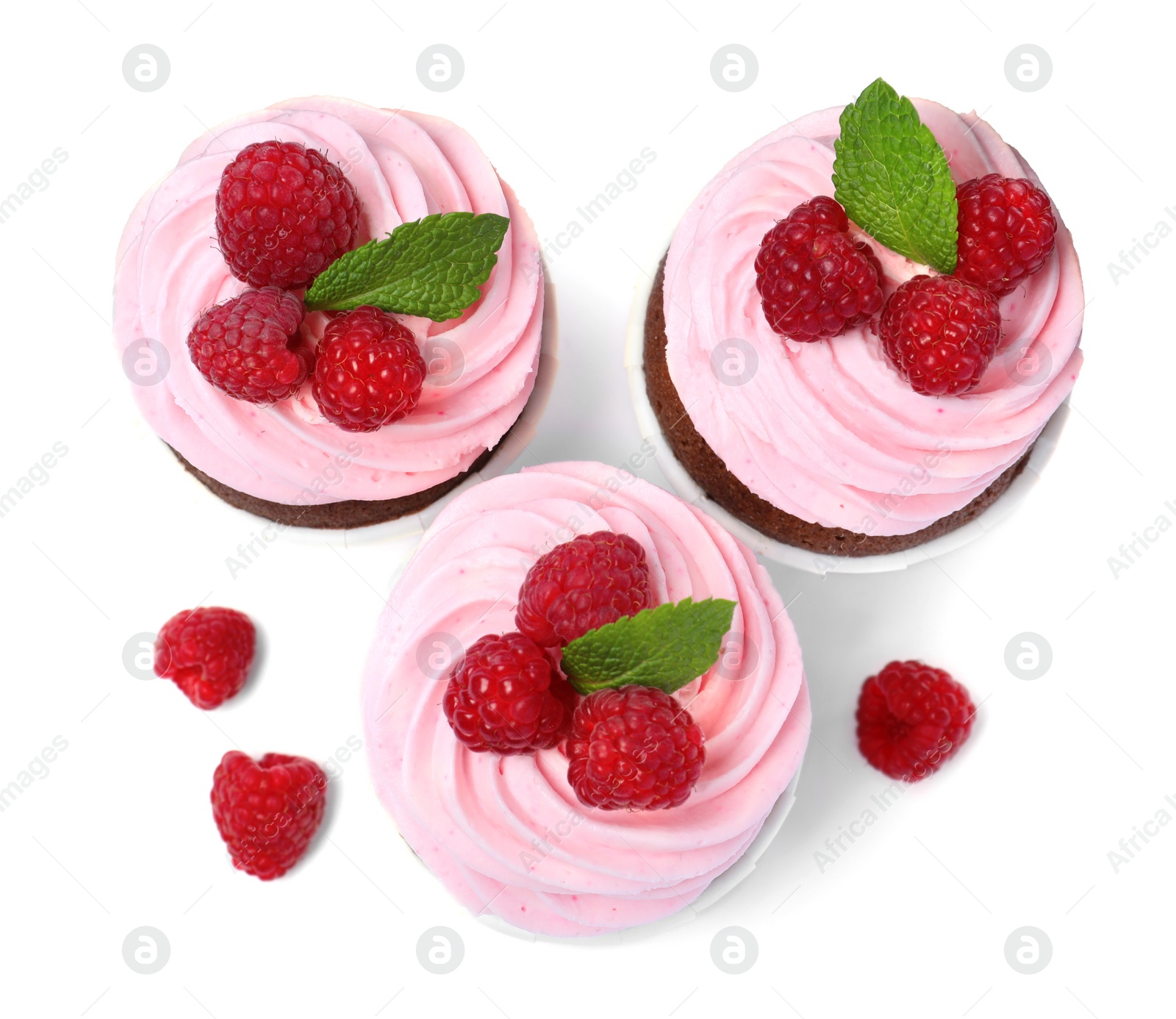 Photo of Sweet cupcakes with fresh raspberries on white background, top view