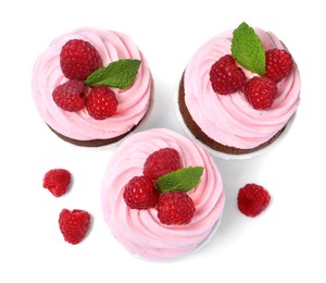 Sweet cupcakes with fresh raspberries on white background, top view