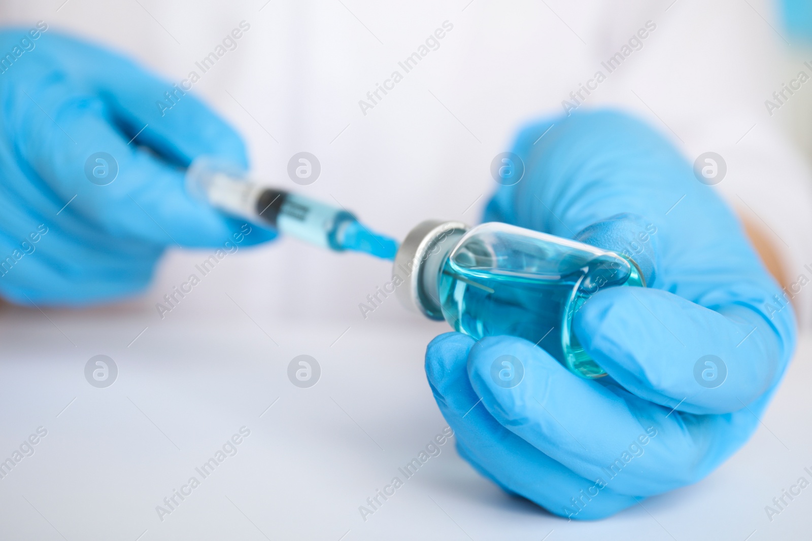 Photo of Doctor filling syringe with medication, closeup. Vaccination and immunization