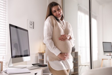Photo of Pregnant woman working at home. Maternity leave