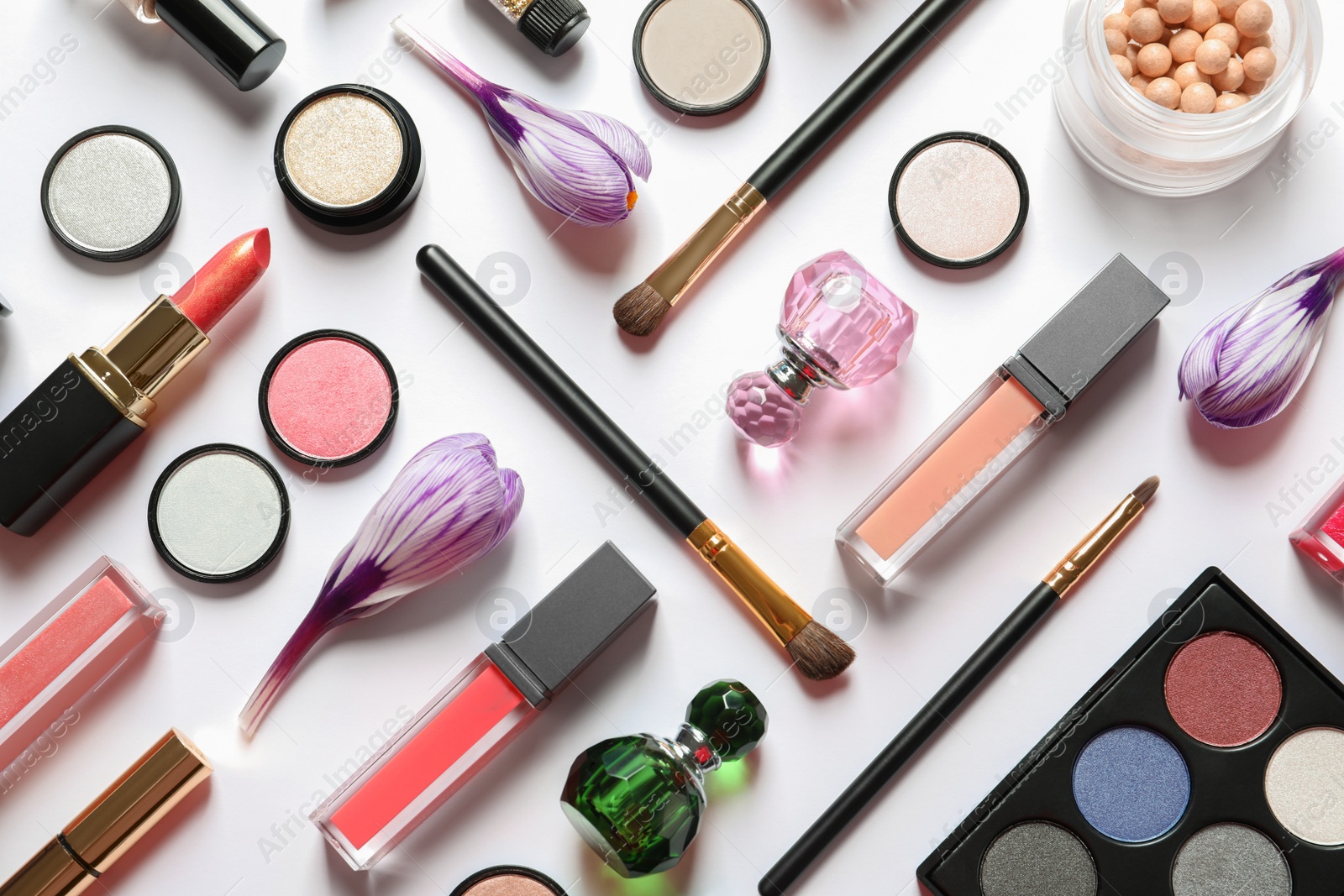 Photo of Different makeup products and flowers on white background, top view