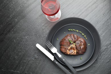 Tasty grilled beef meat served on black table, flat lay. Space for text