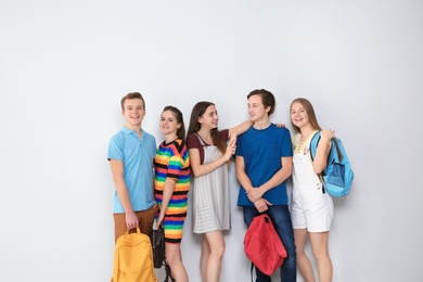 Photo of Group of teenagers on light background. Youth lifestyle and friendship