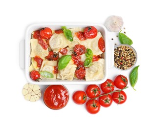 Photo of Tasty ravioli with tomato sauce and different ingredients on white background, flat lay