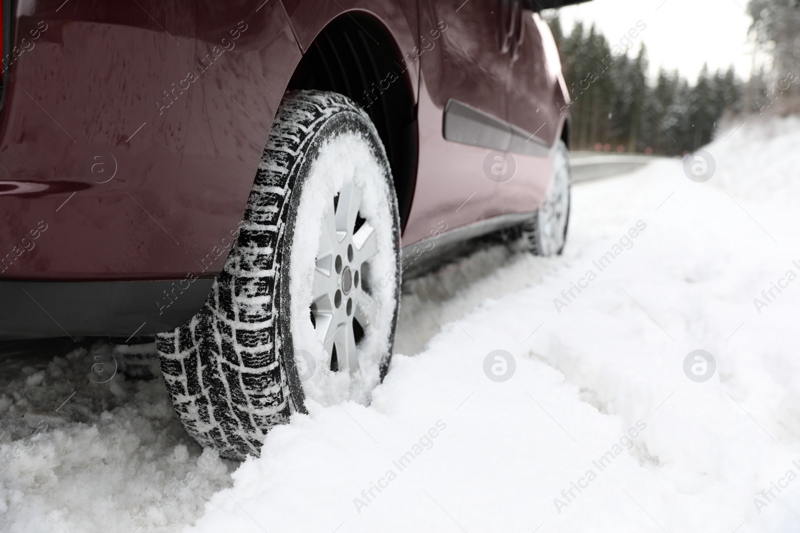 Photo of Closeup view of car in snow near road. Space for text