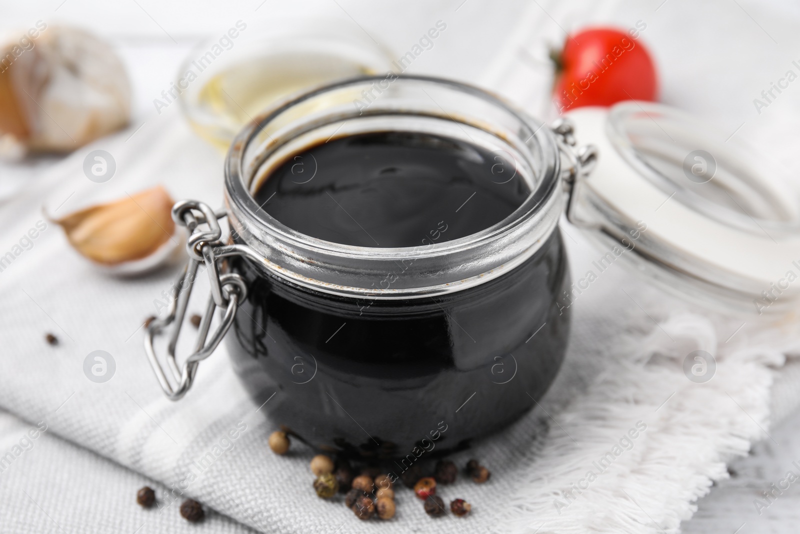 Photo of Organic balsamic vinegar and cooking ingredients on table, closeup