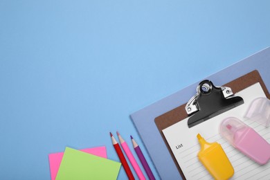 Photo of Flat lay composition with different school stationery on light blue background, space for text. Back to school
